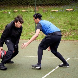 Basketball going through legs to avoid a tackle