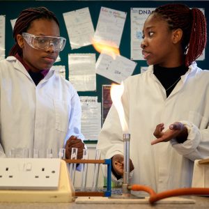 students in a lab using Bunsen burner