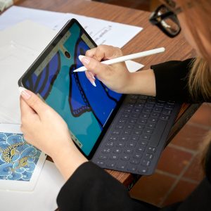 a girl drawing on an iPad