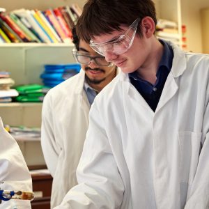 student using a Bunsen burner