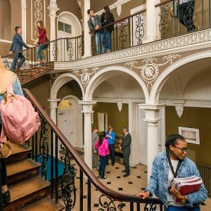 Pupils walking up grand stairs