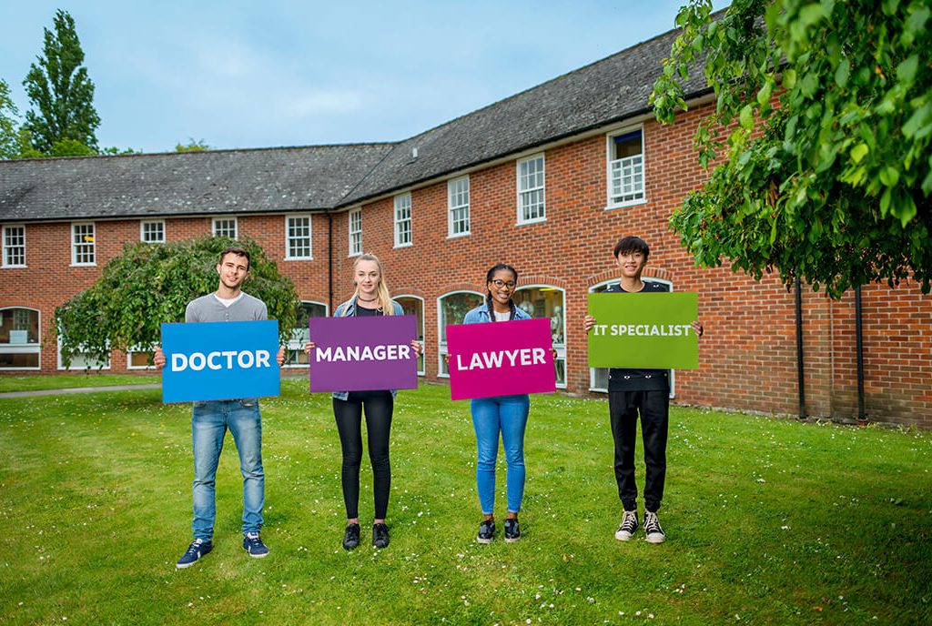 Job titles held up with cardboard that students are holding