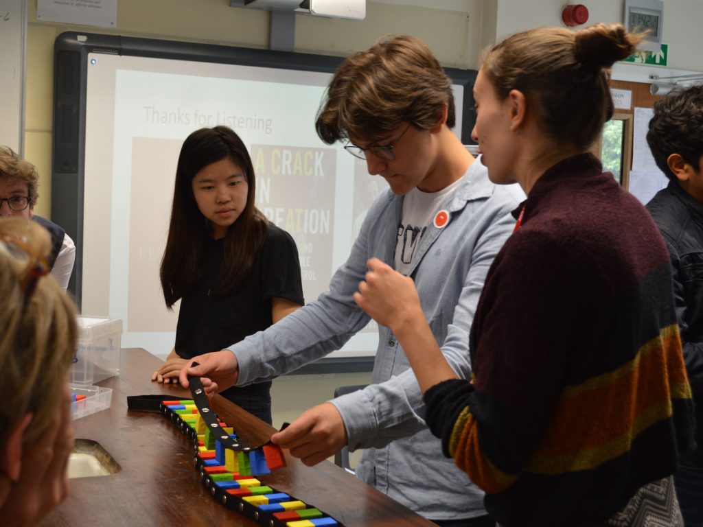 Students playing with a toy at a career day